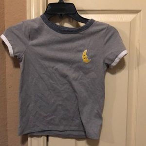 Grey shirt with a moon and white strips on arm